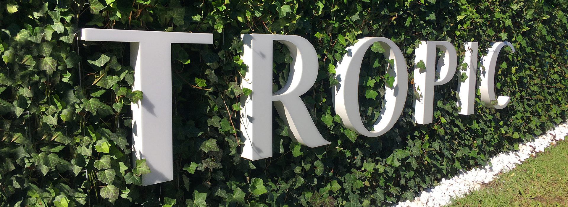 Large Tropic logo on a leafy background